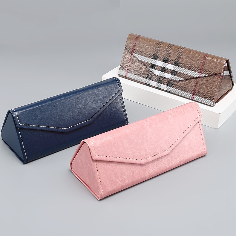 Triangular folding glasses cases in navy, pink and a checked pattern